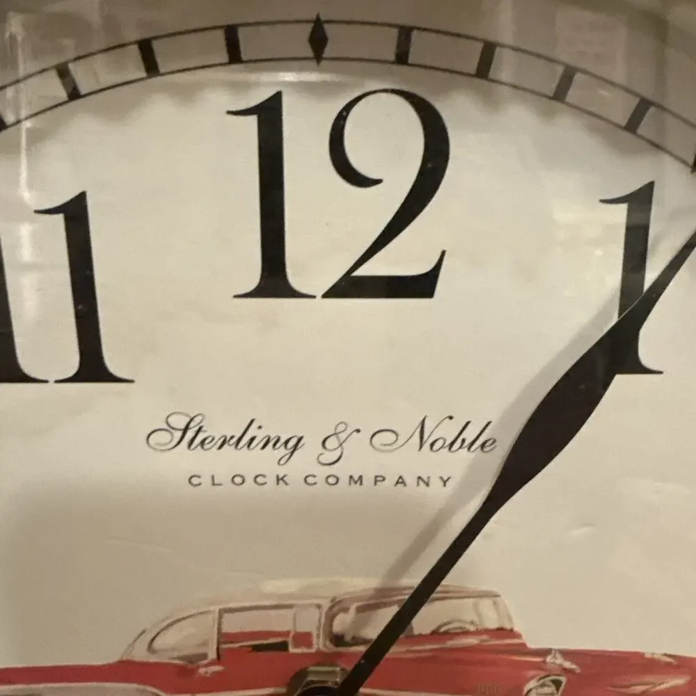 Sterling & NobleVNTGwall clock with a brown and gold ripple wood frame and a red